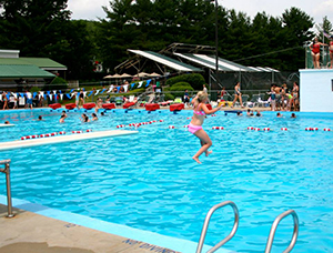 kid jumping in pool